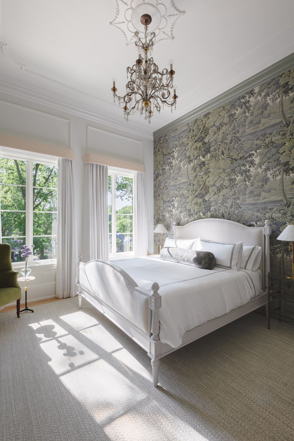 Light-filled bedroom with textured neutral wallpaper accent wall